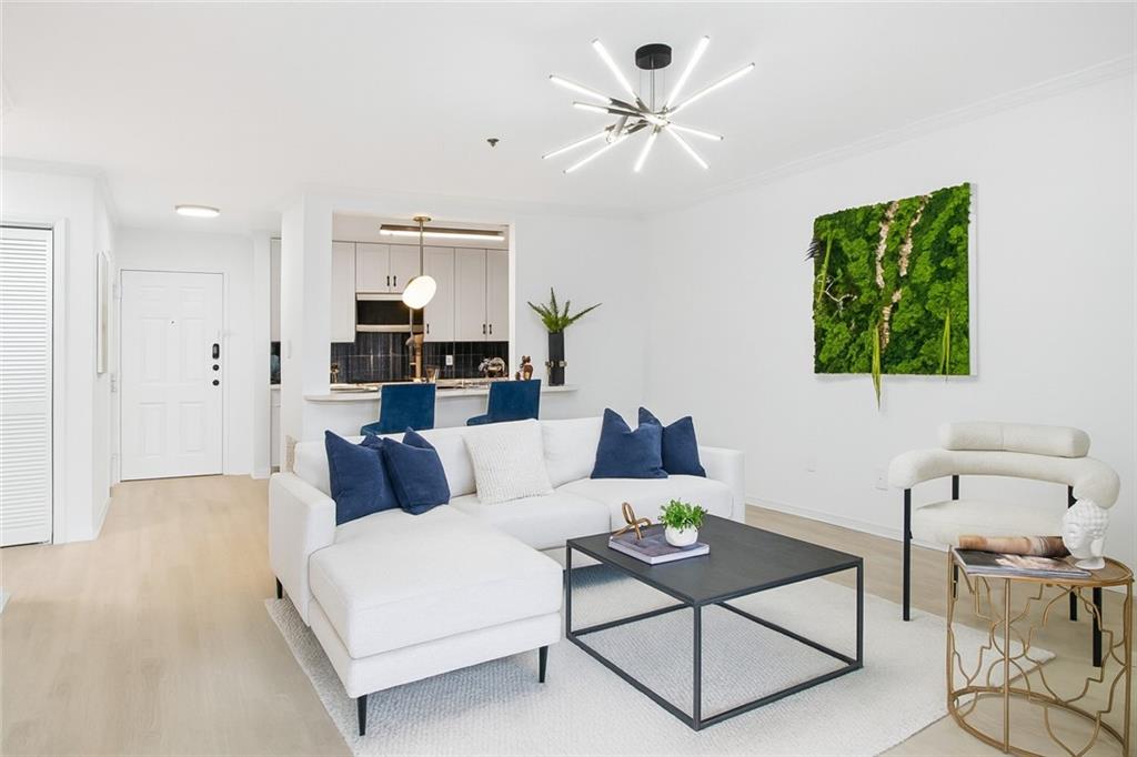 970 Sidney Marcus Boulevard Northeast, Unit 2203 Atlanta, GA 30324 - Photo 10 of 39 a living room with furniture and a chandelier