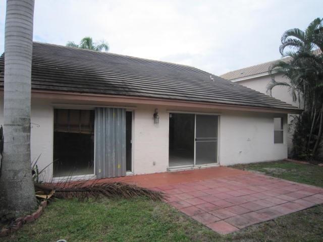 7408 Shell Ridge Terrace Lake Worth, FL 33467 - Photo 4 of 23 front view of a house with a yard