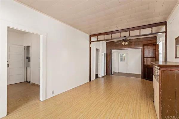 a view of empty room with wooden floor and cabinet