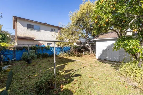 a view of a yard in front of a house with trees