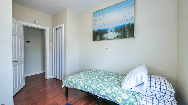 a bedroom with a bed and a painting on the wall