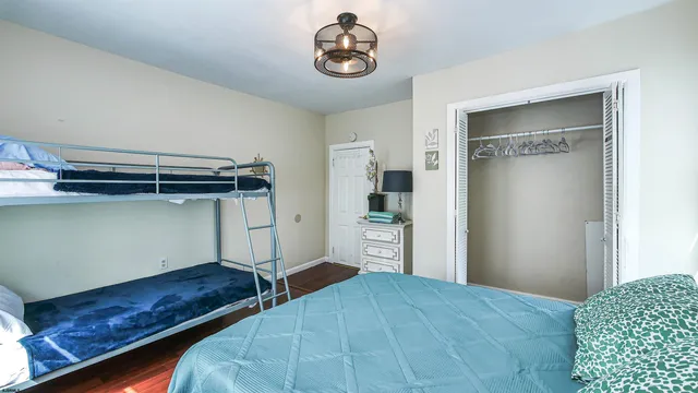 a bedroom with a bed and cabinets