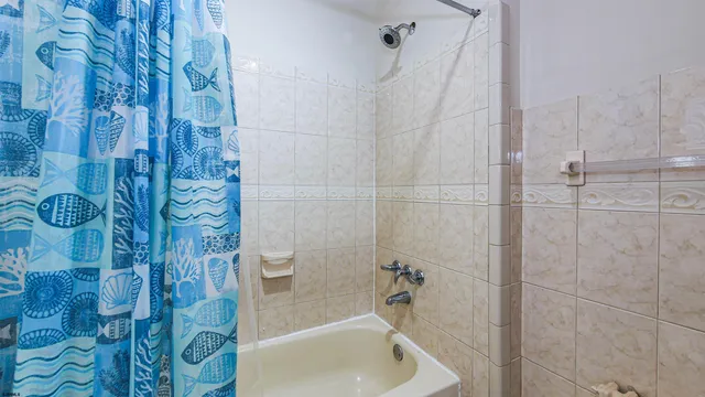 a bathroom with a bathtub and shower