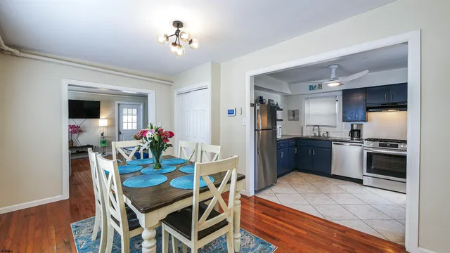a kitchen with stainless steel appliances kitchen island granite countertop a dining table and chairs