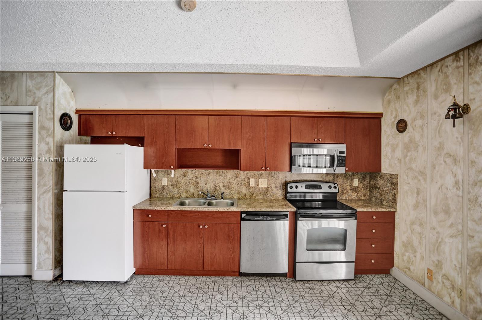 837 Washington Street Hollywood, FL 33019 - Photo 15 of 65 a kitchen with a stove and a refrigerator