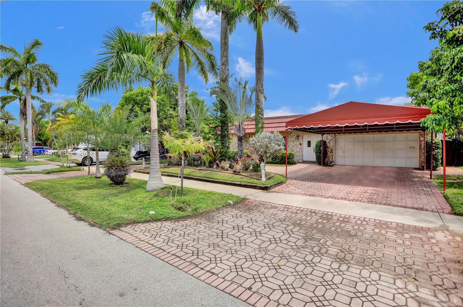 837 Washington Street Hollywood, FL 33019 - Photo 2 of 65 a view of a house with a yard and coconut trees