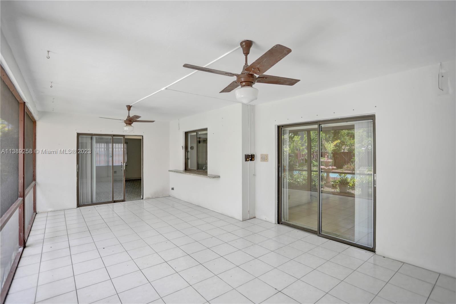 837 Washington Street Hollywood, FL 33019 - Photo 26 of 65 a view of an empty room with window and chandelier fan
