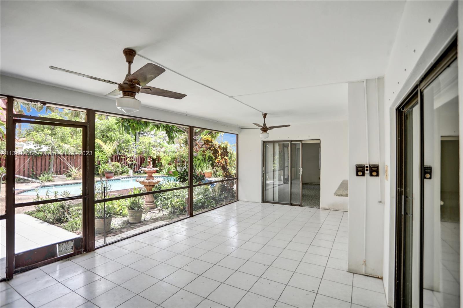 837 Washington Street Hollywood, FL 33019 - Photo 27 of 65 a view of empty room with wooden floor and fan