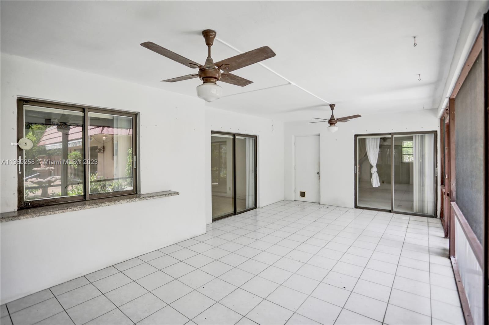 837 Washington Street Hollywood, FL 33019 - Photo 29 of 65 a view of a livingroom with a ceiling fan and window