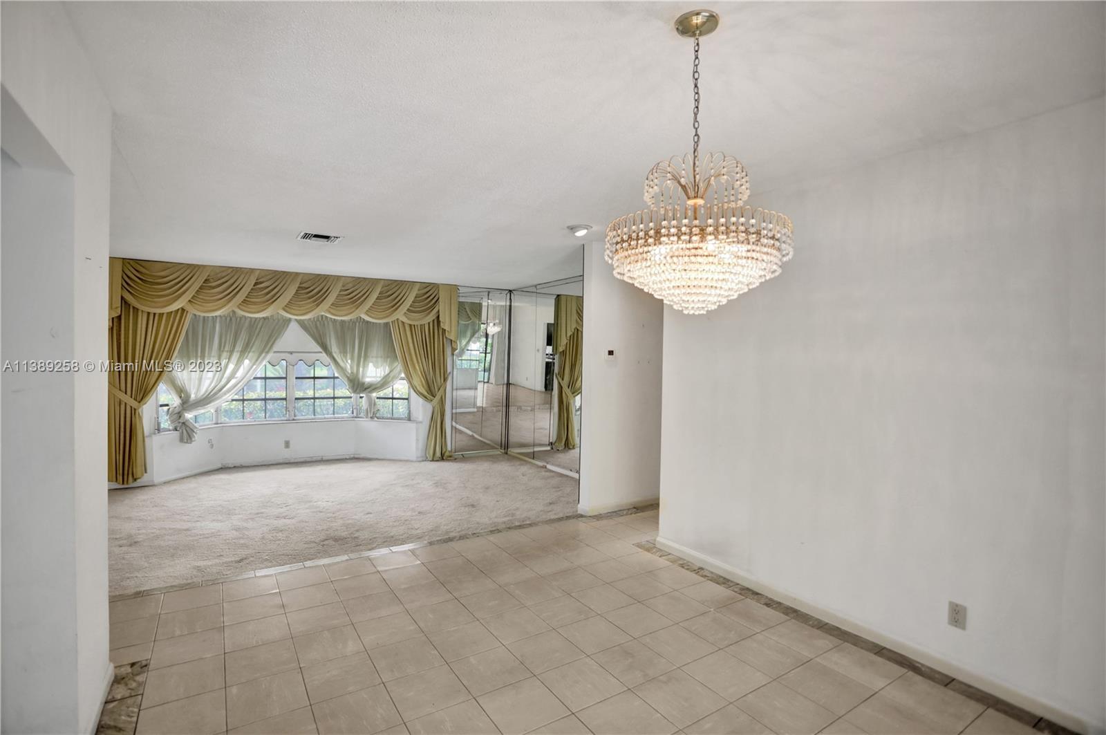 837 Washington Street Hollywood, FL 33019 - Photo 35 of 65 a view of a room with window and a chandelier