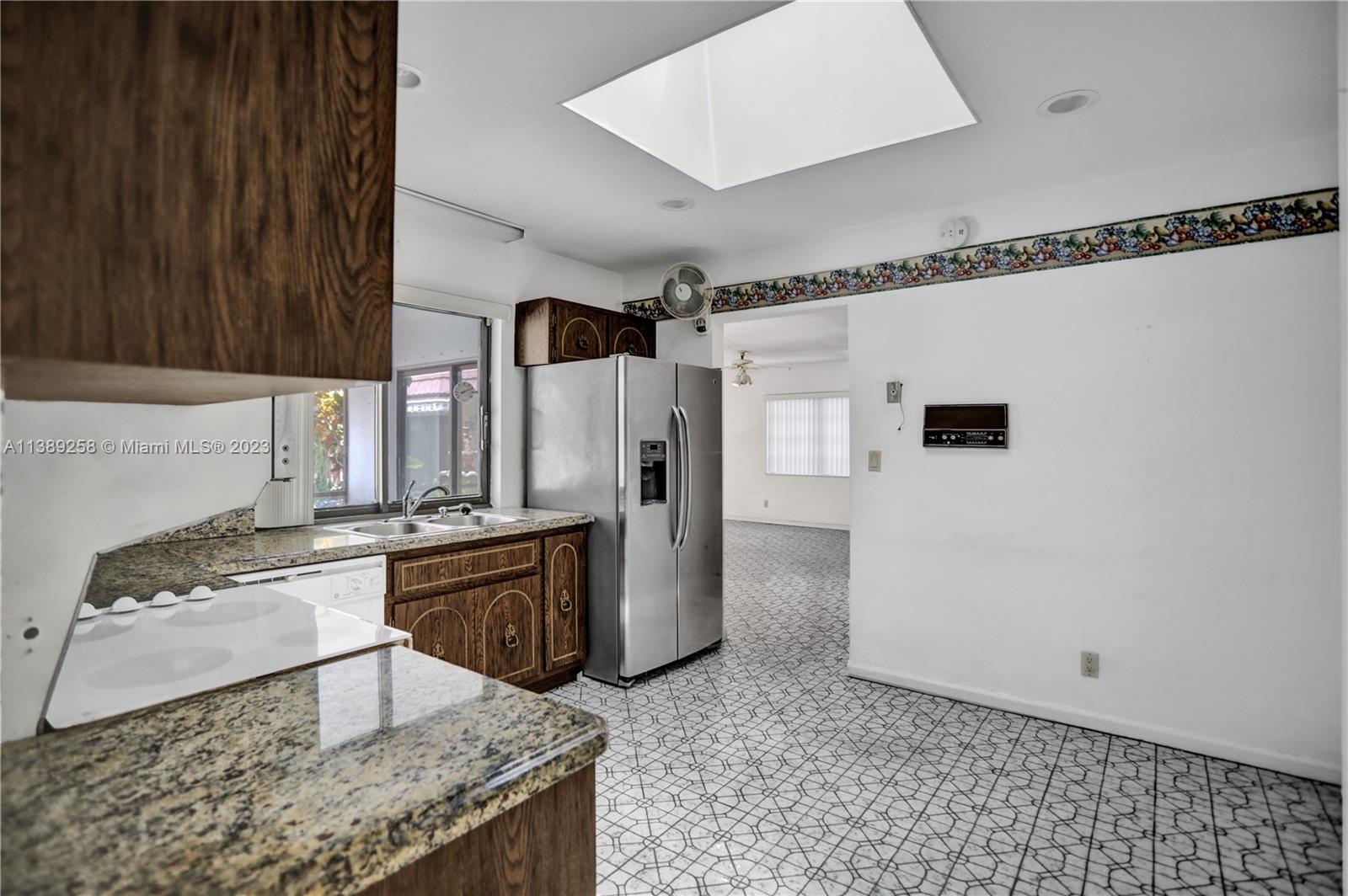 837 Washington Street Hollywood, FL 33019 - Photo 36 of 65 a kitchen with stainless steel appliances granite countertop a sink stove and refrigerator
