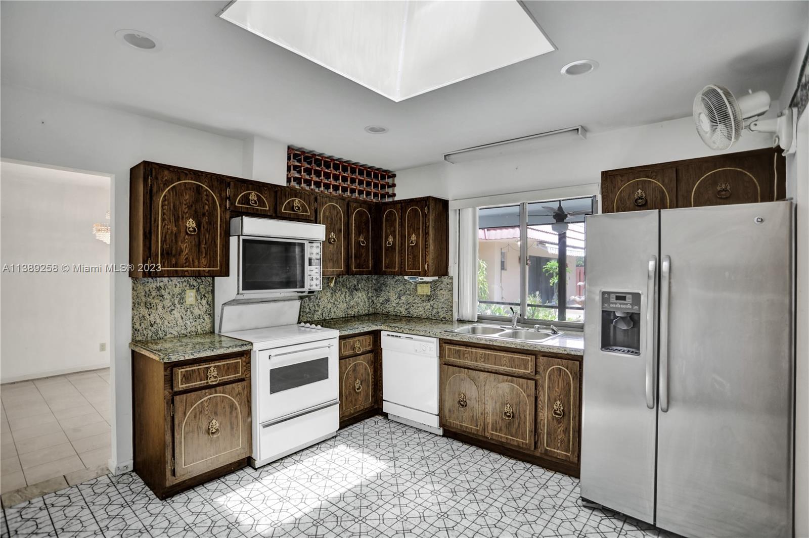 837 Washington Street Hollywood, FL 33019 - Photo 37 of 65 a kitchen with stainless steel appliances granite countertop a refrigerator a stove and a sink