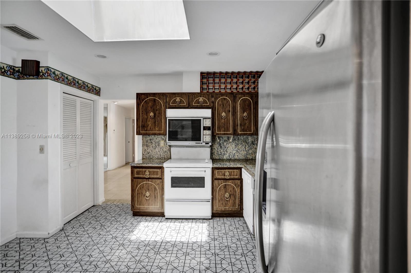 837 Washington Street Hollywood, FL 33019 - Photo 38 of 65 a kitchen with stainless steel appliances granite countertop a refrigerator and a stove