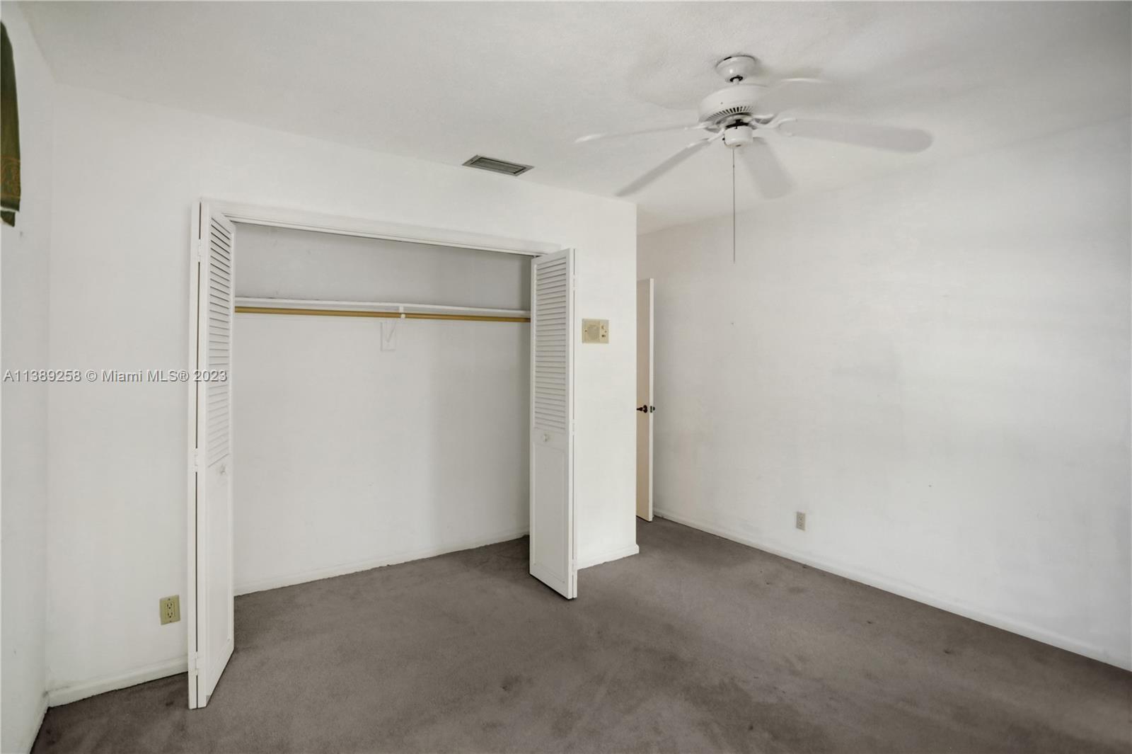 837 Washington Street Hollywood, FL 33019 - Photo 46 of 65 an empty room with a ceiling fan and a window