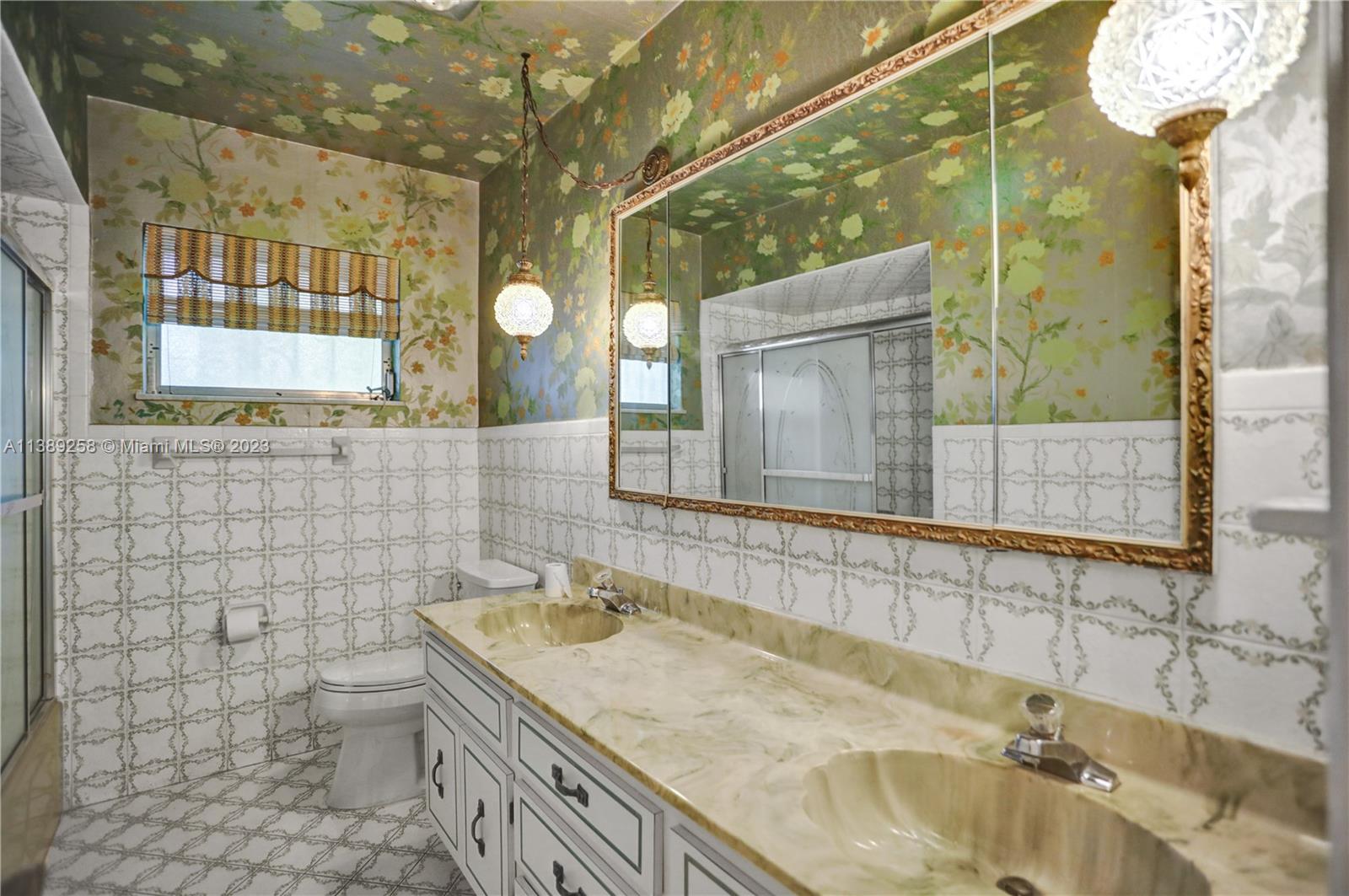 837 Washington Street Hollywood, FL 33019 - Photo 54 of 65 a bathroom with a granite countertop sink and a mirror