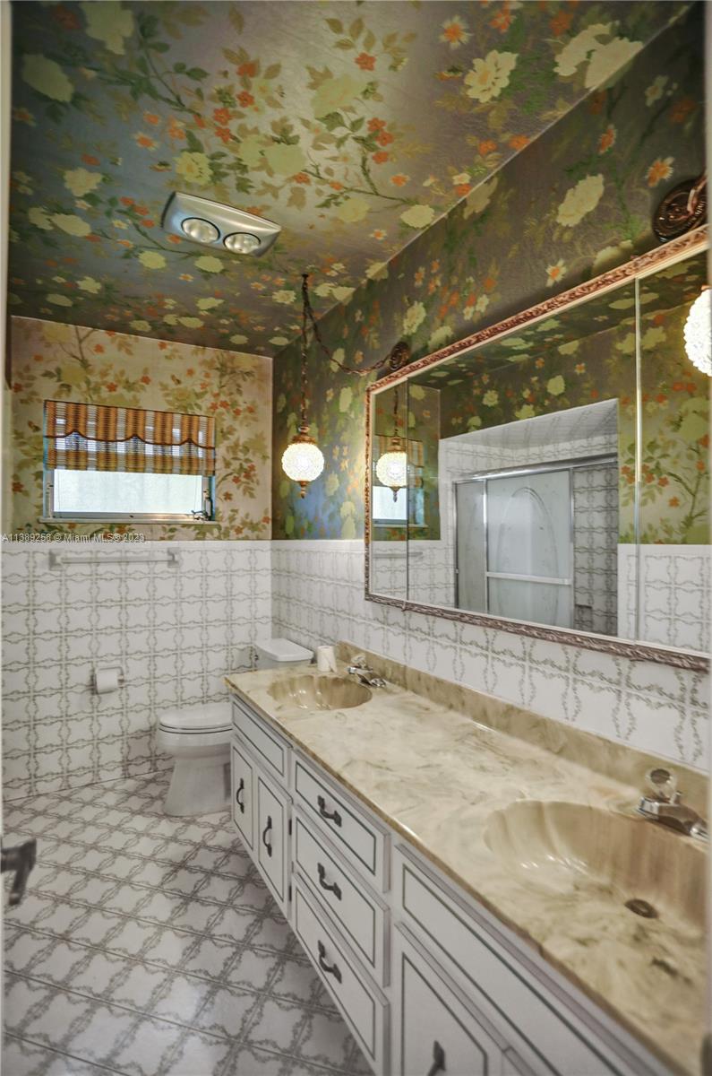 837 Washington Street Hollywood, FL 33019 - Photo 55 of 65 a bathroom with a sink and a mirror