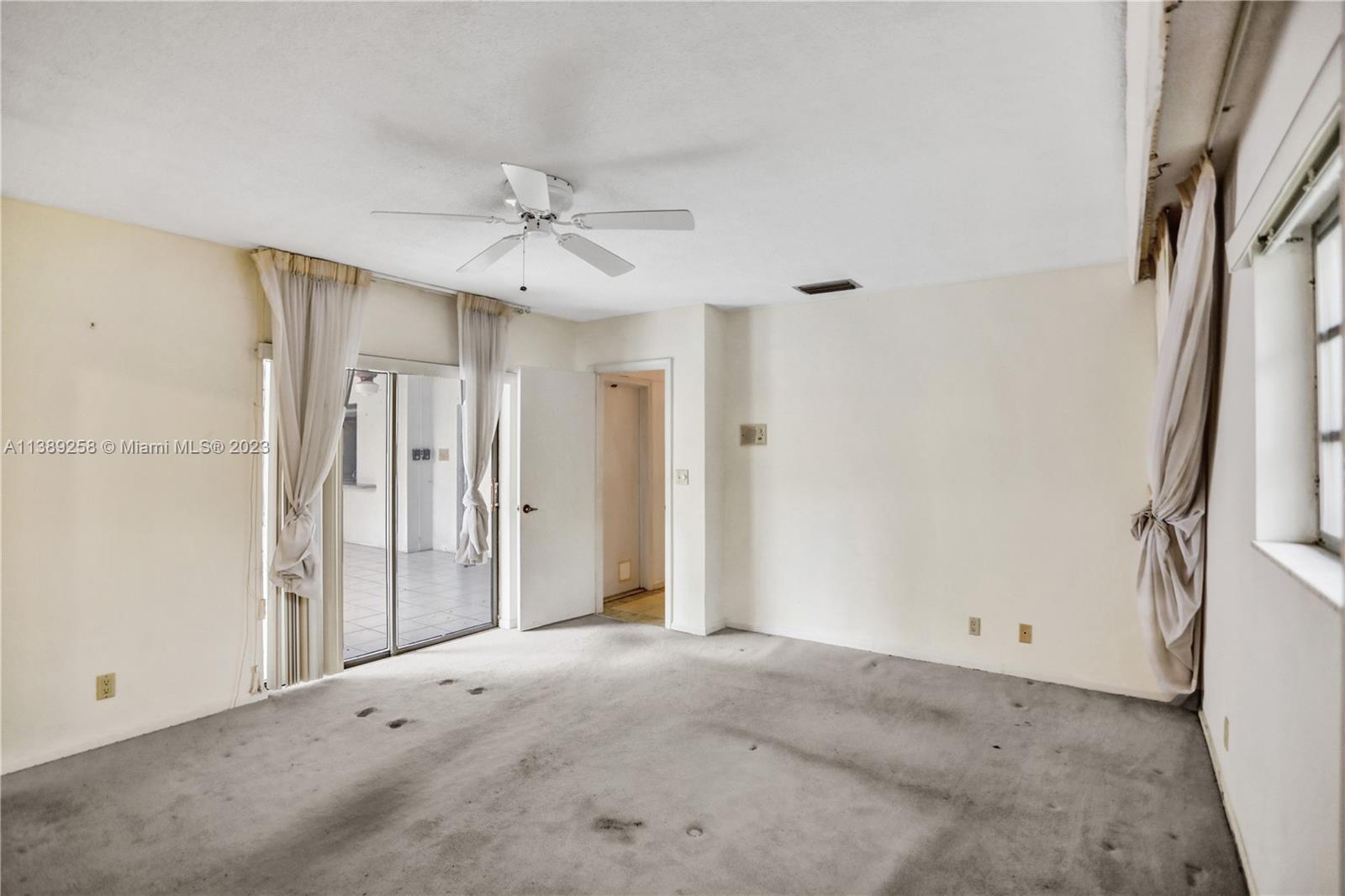 837 Washington Street Hollywood, FL 33019 - Photo 58 of 65 a view of a livingroom with a chandelier fan and windows