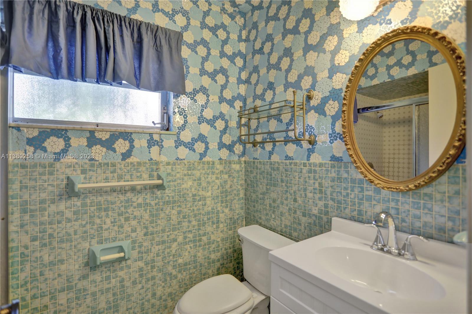 837 Washington Street Hollywood, FL 33019 - Photo 61 of 65 a bathroom with a sink mirror vanity and toilet