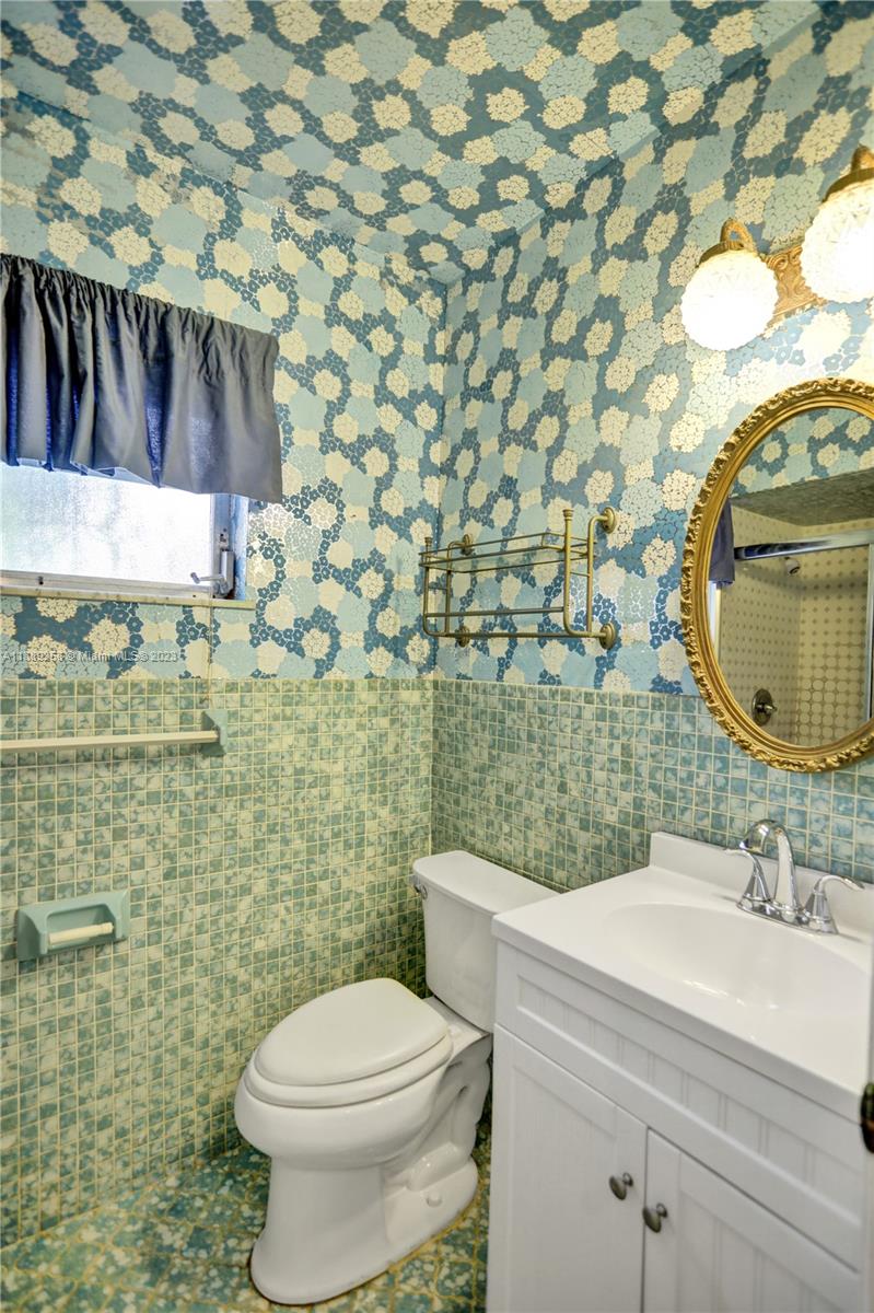 837 Washington Street Hollywood, FL 33019 - Photo 62 of 65 a bathroom with a toilet and a sink
