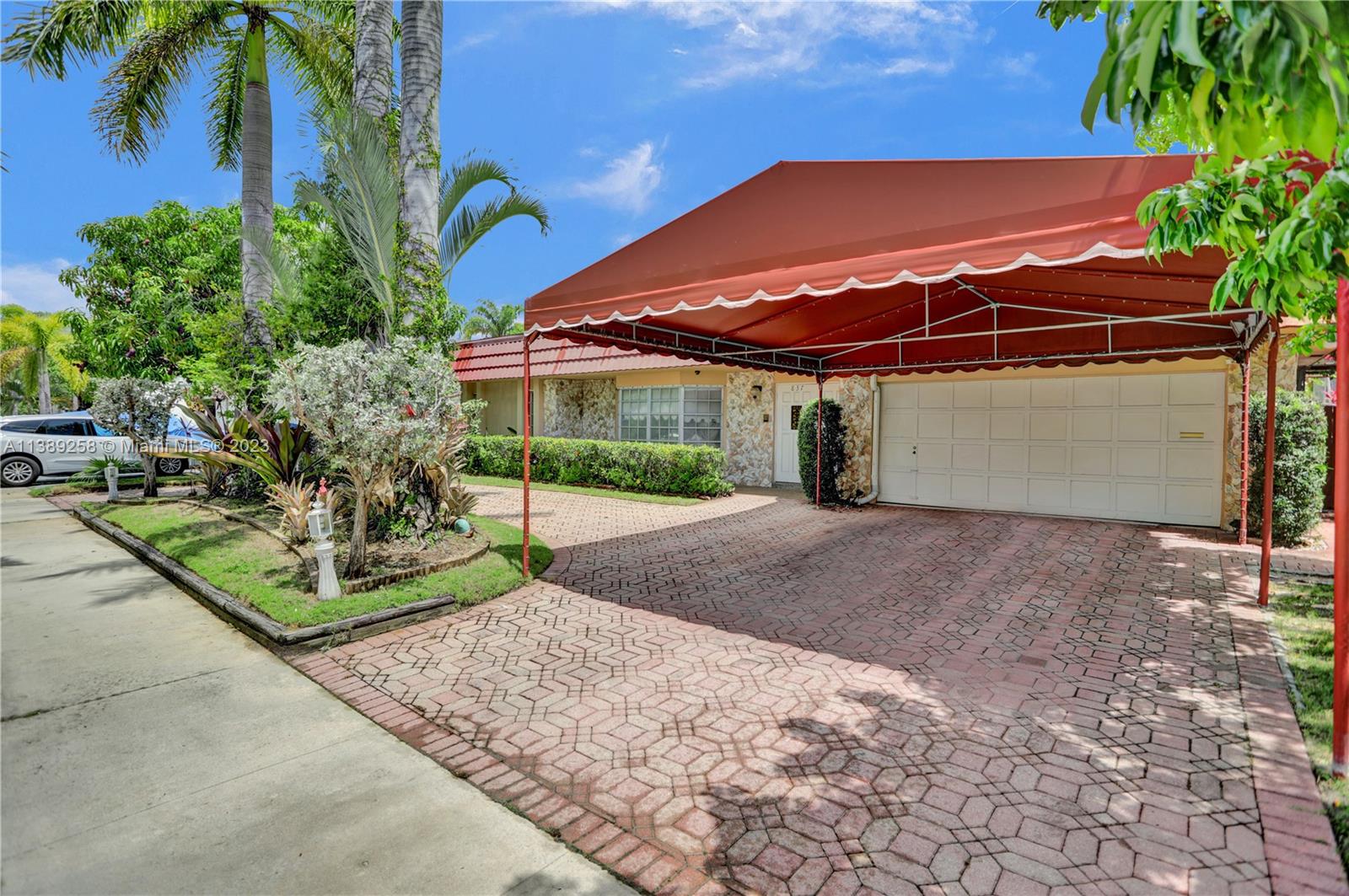 837 Washington Street Hollywood, FL 33019 - Photo 7 of 65 a view of a house with a yard and potted plants