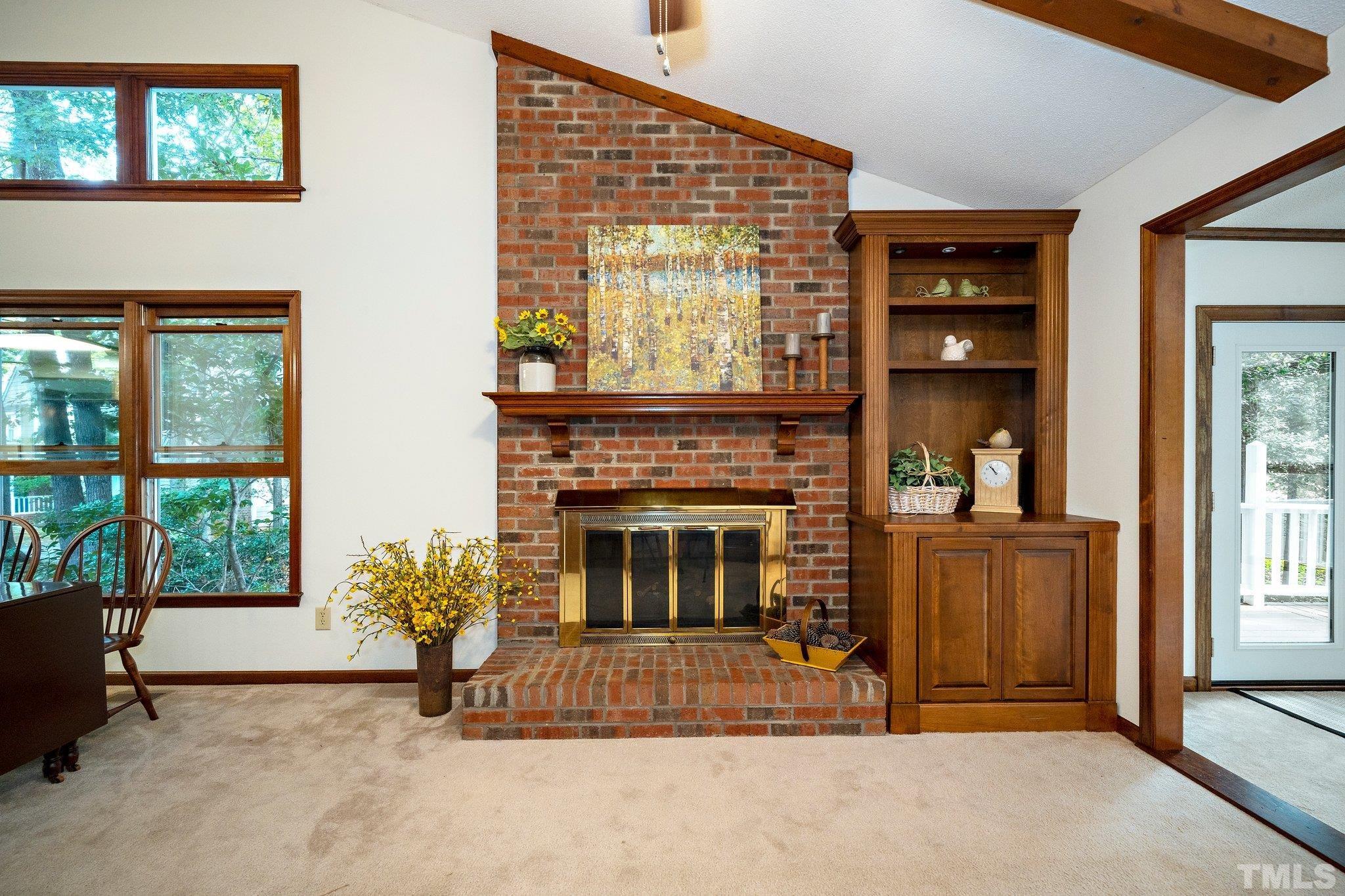 902 Bridge Way Raleigh, NC 27615 - Photo 12 of 27 a view of an empty room with a fireplace and a window