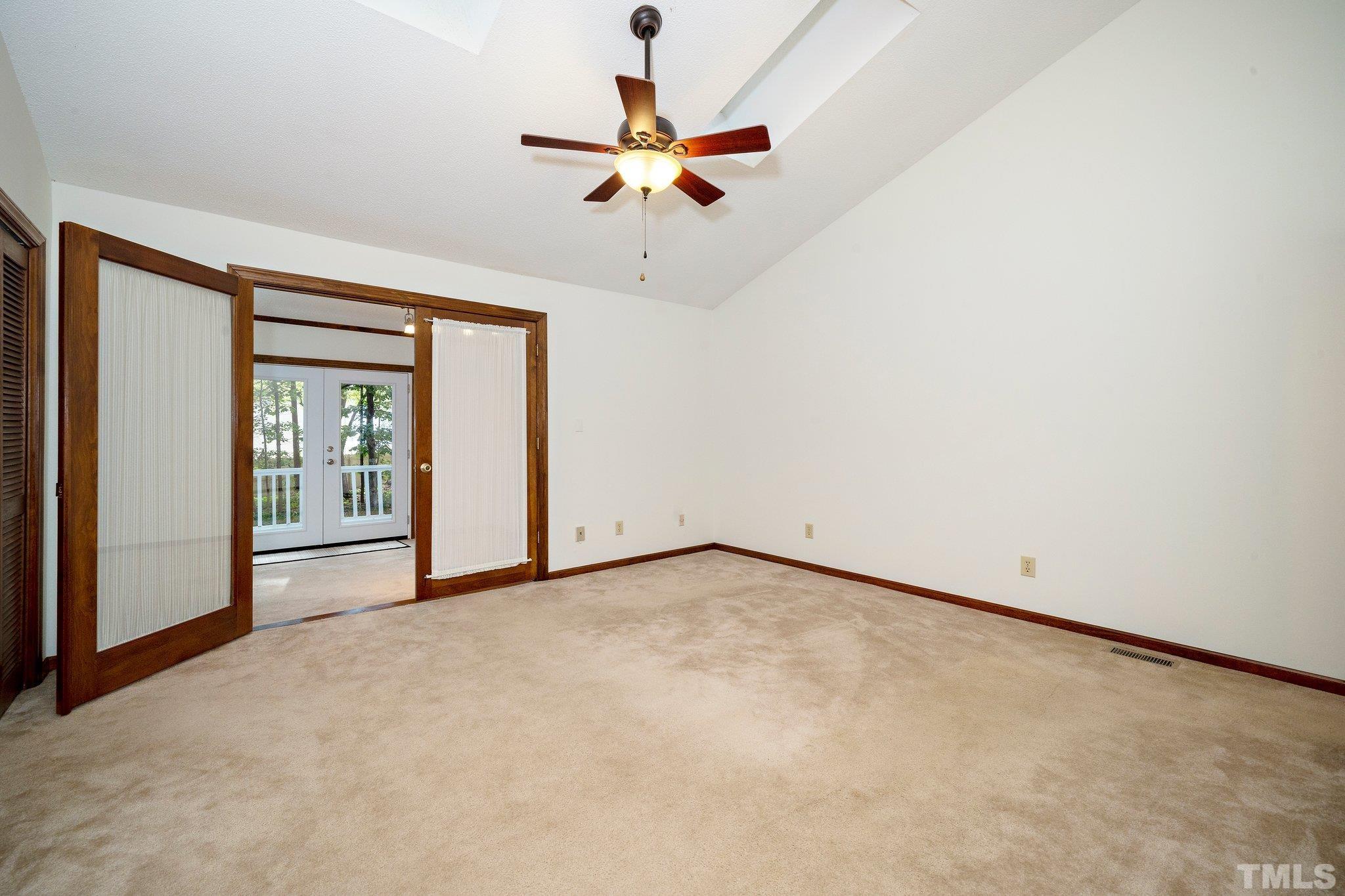 902 Bridge Way Raleigh, NC 27615 - Photo 15 of 27 an empty room with a ceiling fan and window