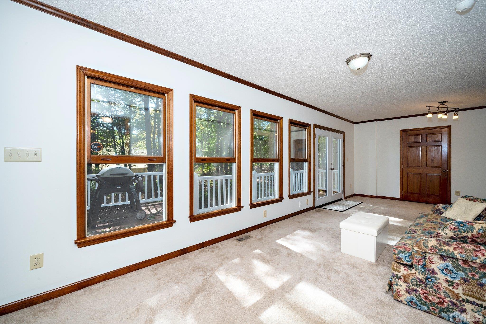 902 Bridge Way Raleigh, NC 27615 - Photo 18 of 27 a view of a big room with windows and chandelier