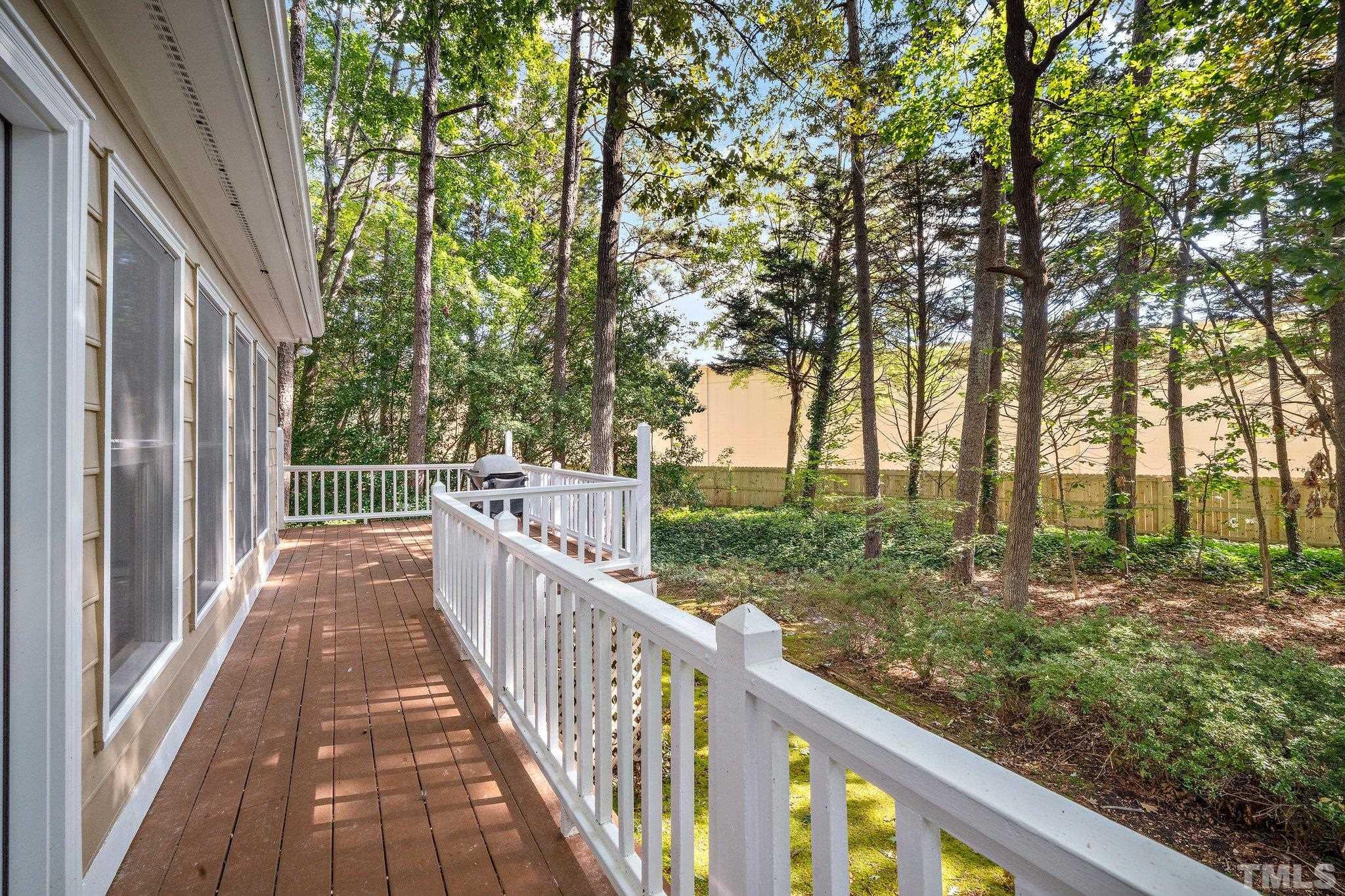 902 Bridge Way Raleigh, NC 27615 - Photo 21 of 27 a view of a wooden deck next to a yard