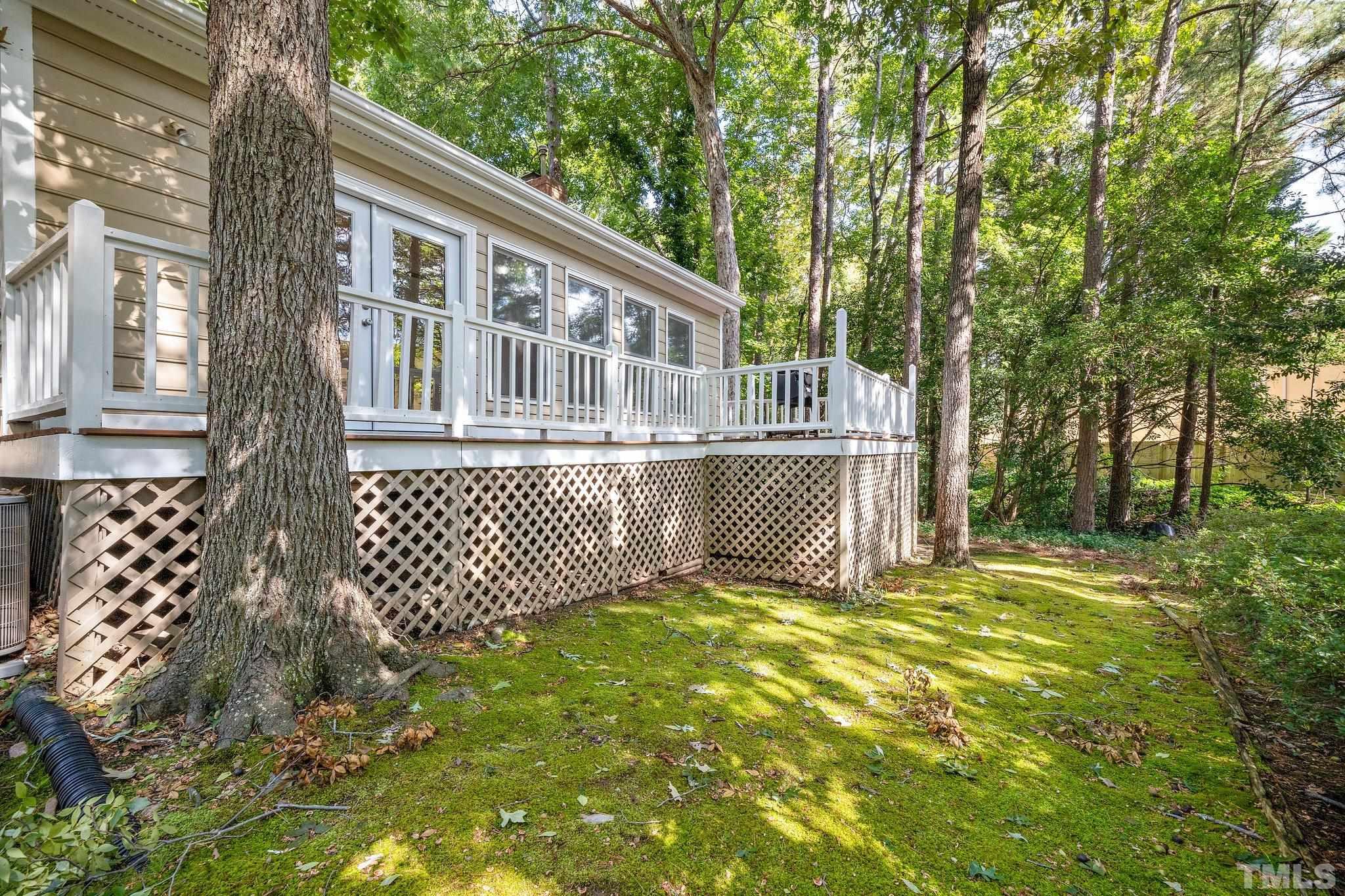 902 Bridge Way Raleigh, NC 27615 - Photo 23 of 27 a view of a house with a wooden deck and a yard