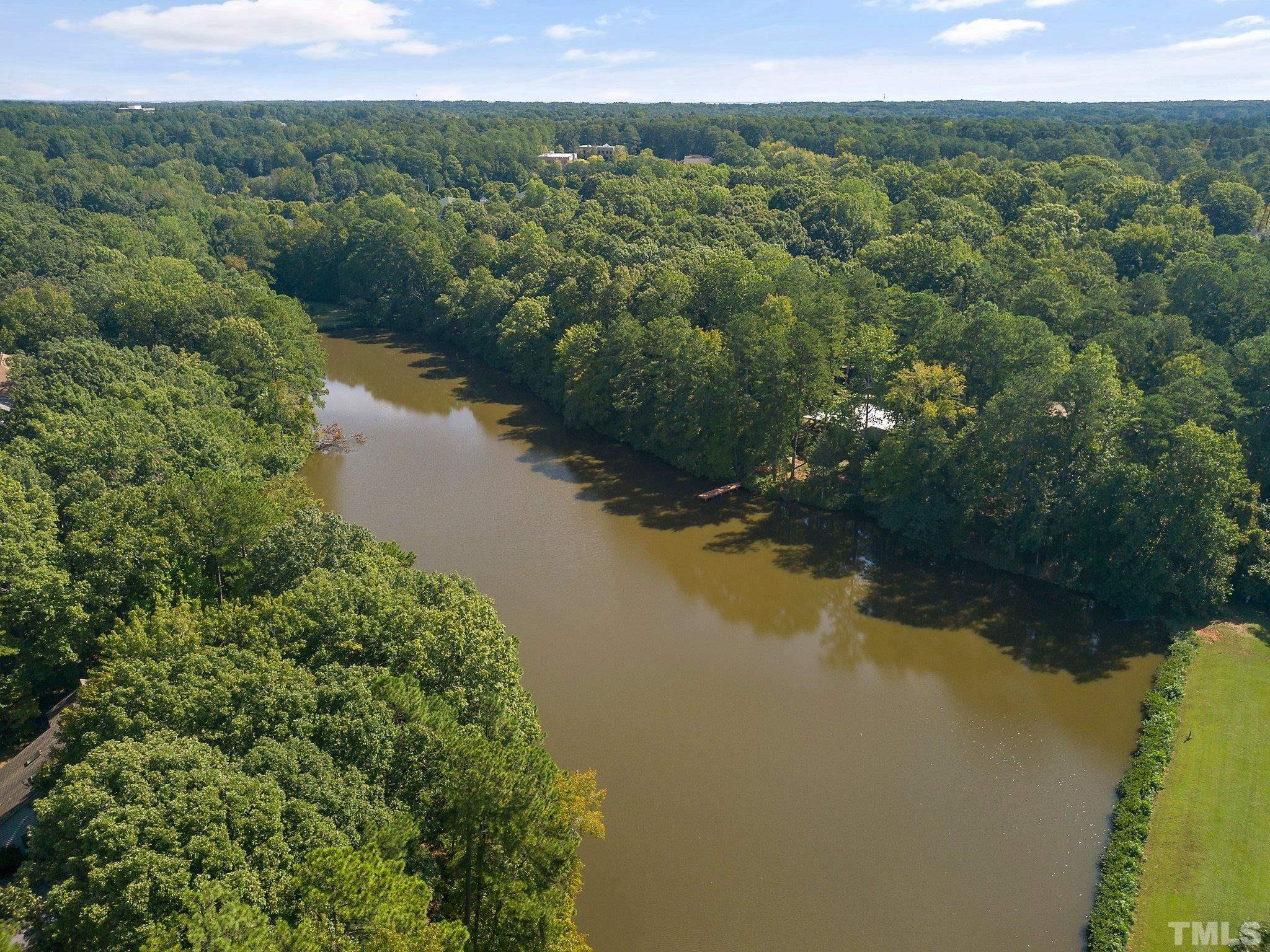 902 Bridge Way Raleigh, NC 27615 - Photo 27 of 27 a view of a lake with green landscape