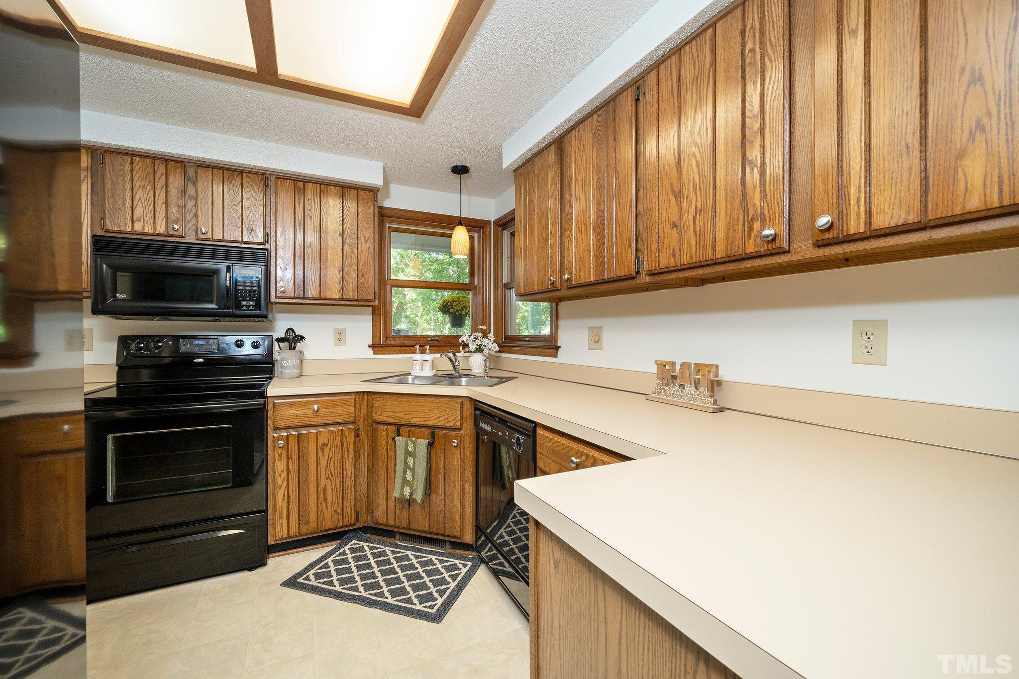 902 Bridge Way Raleigh, NC 27615 - Photo 8 of 27 a kitchen with a sink a stove and cabinets