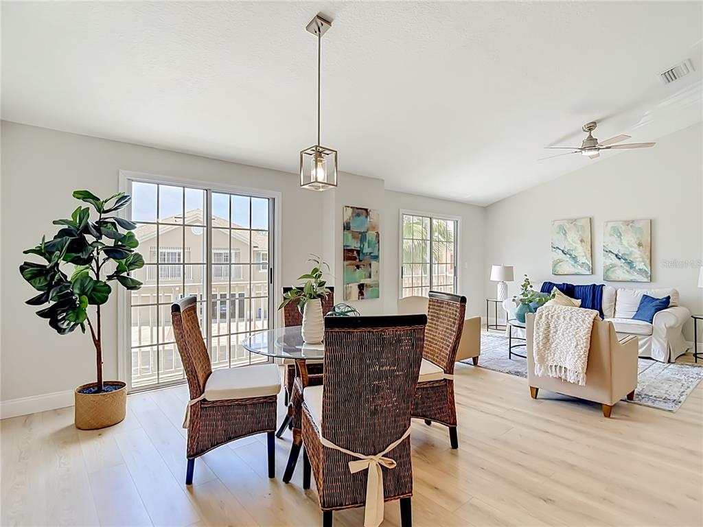 5310 Anhinga Trail New Port Richey, FL 34653 - Photo 13 of 27 a view of a dining room with furniture window and wooden floor