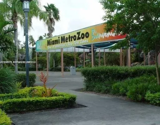 a view of a house with backyard and a tree