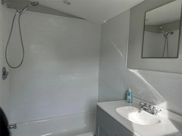 a bathroom with a sink vanity and a mirror