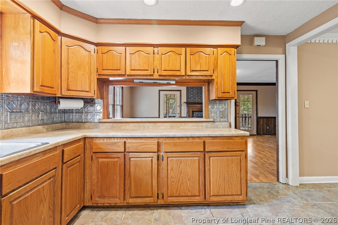 5605 MacGregor Court Fayetteville, NC 28304 - Photo 18 of 49 a kitchen with stainless steel appliances granite countertop a refrigerator and wooden cabinets