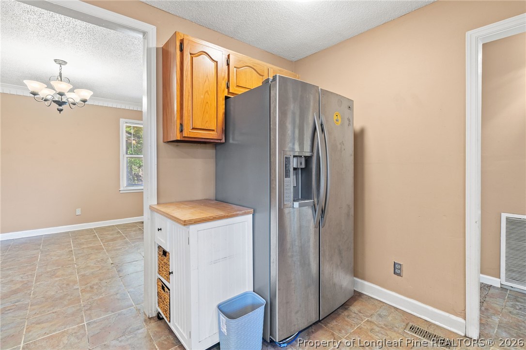 5605 MacGregor Court Fayetteville, NC 28304 - Photo 19 of 49 a kitchen with a refrigerator and a sink