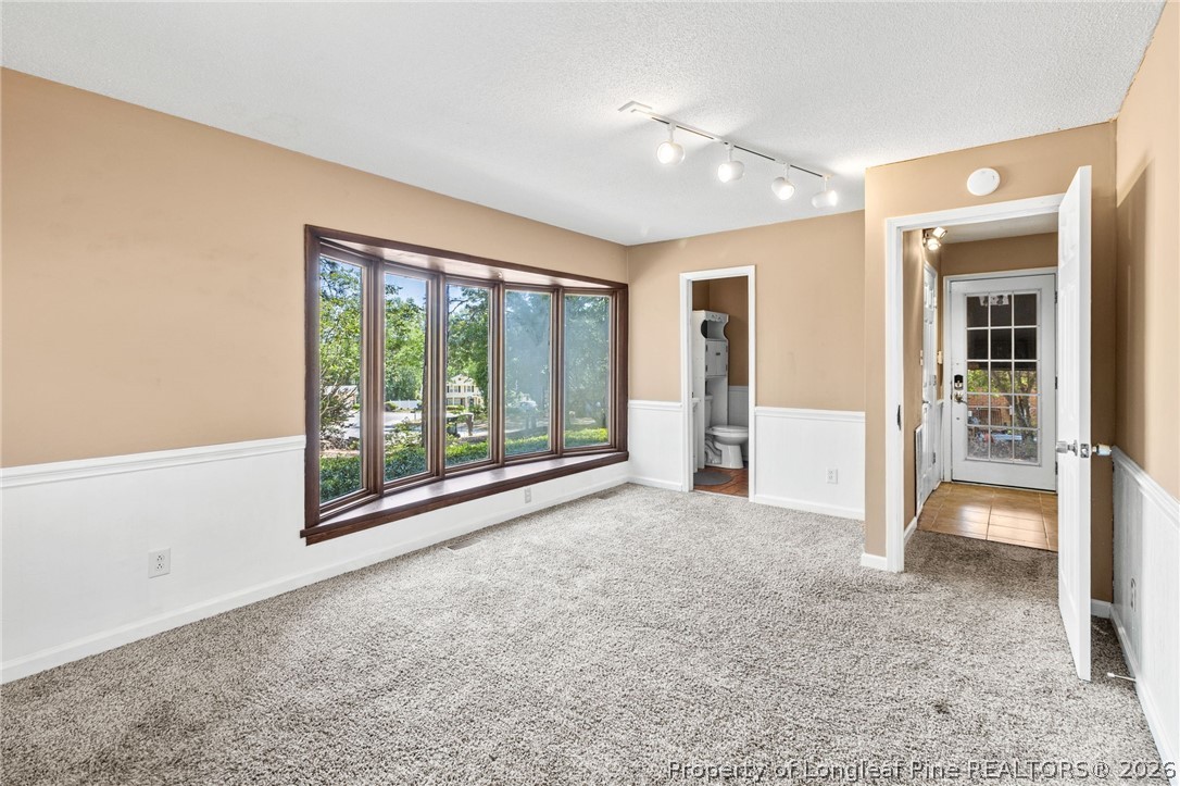 5605 MacGregor Court Fayetteville, NC 28304 - Photo 23 of 49 an empty room with floor to ceiling windows and an outdoor view