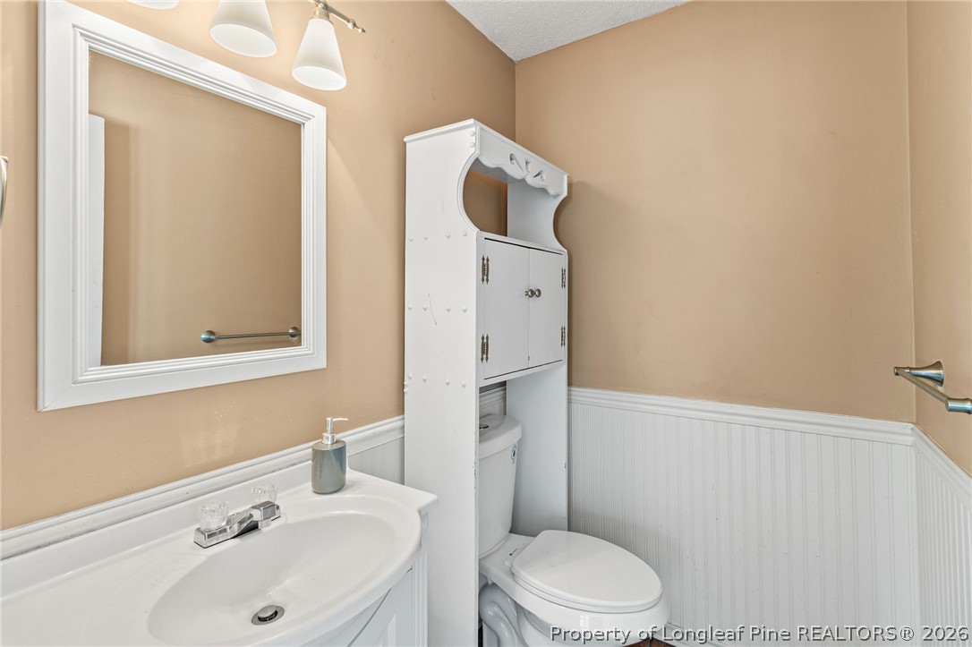 5605 MacGregor Court Fayetteville, NC 28304 - Photo 25 of 49 a bathroom with a sink toilet and mirror