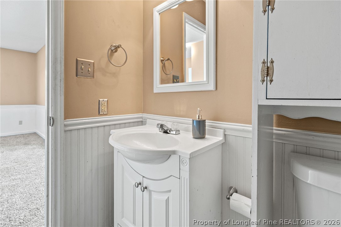 5605 MacGregor Court Fayetteville, NC 28304 - Photo 26 of 49 a bathroom with a sink toilet and vanity