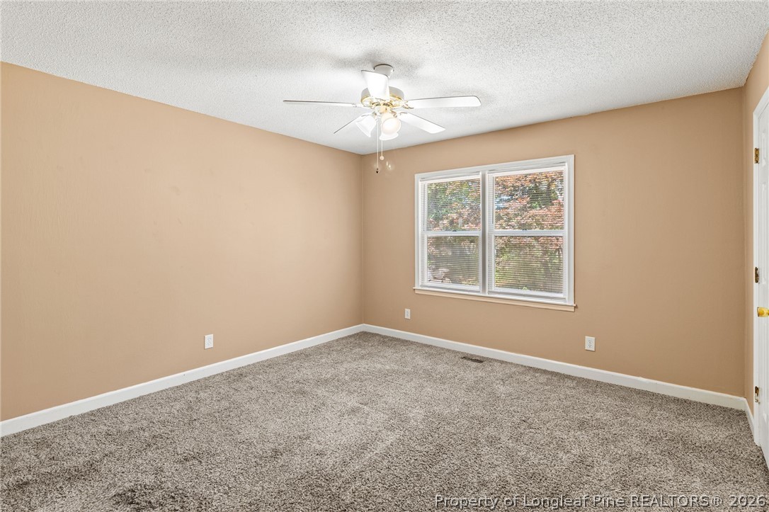 5605 MacGregor Court Fayetteville, NC 28304 - Photo 33 of 49 an empty room with a window and a ceiling fan
