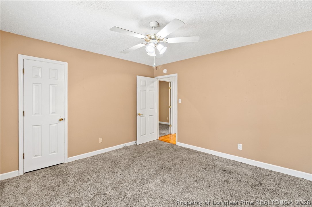 5605 MacGregor Court Fayetteville, NC 28304 - Photo 34 of 49 a view of a room with a ceiling fan and a window