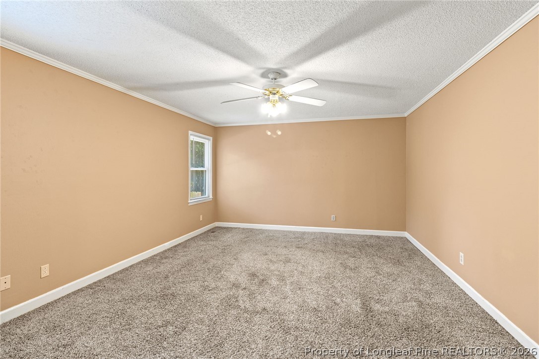 5605 MacGregor Court Fayetteville, NC 28304 - Photo 36 of 49 an empty room with windows and fan