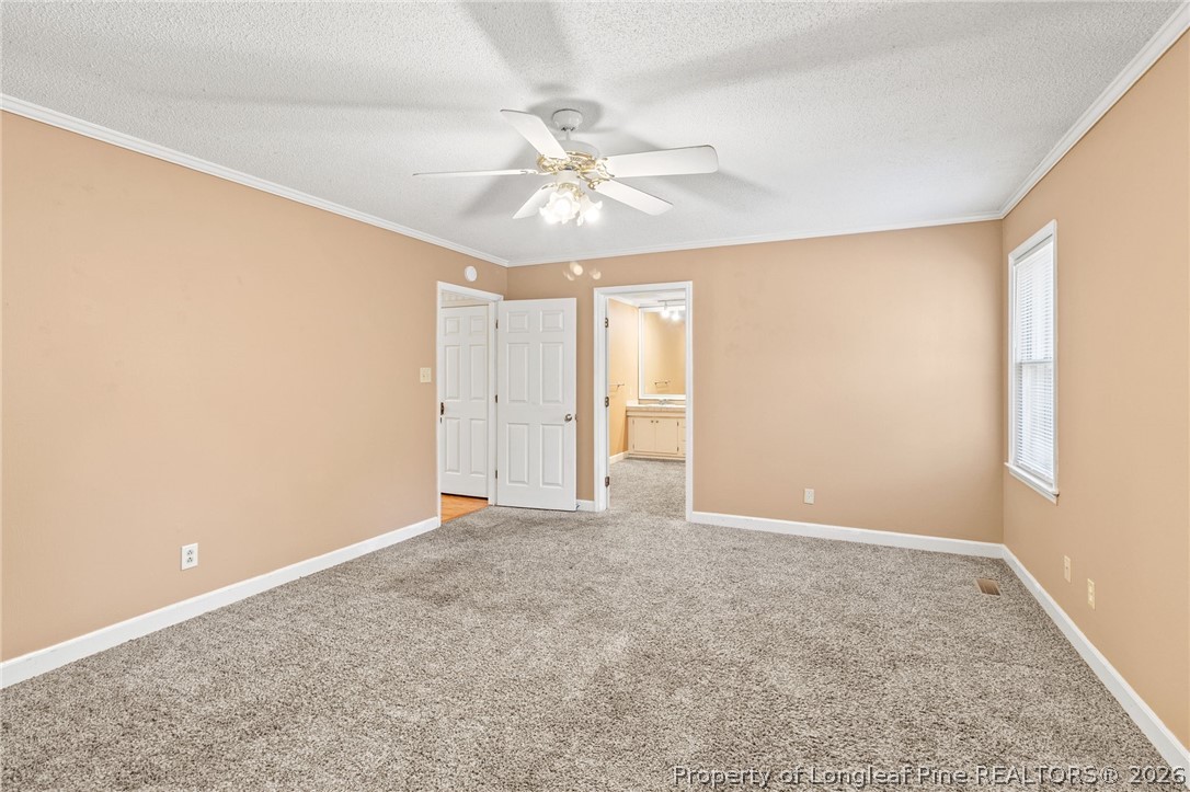 5605 MacGregor Court Fayetteville, NC 28304 - Photo 37 of 49 an empty room with closet and a chandelier fan