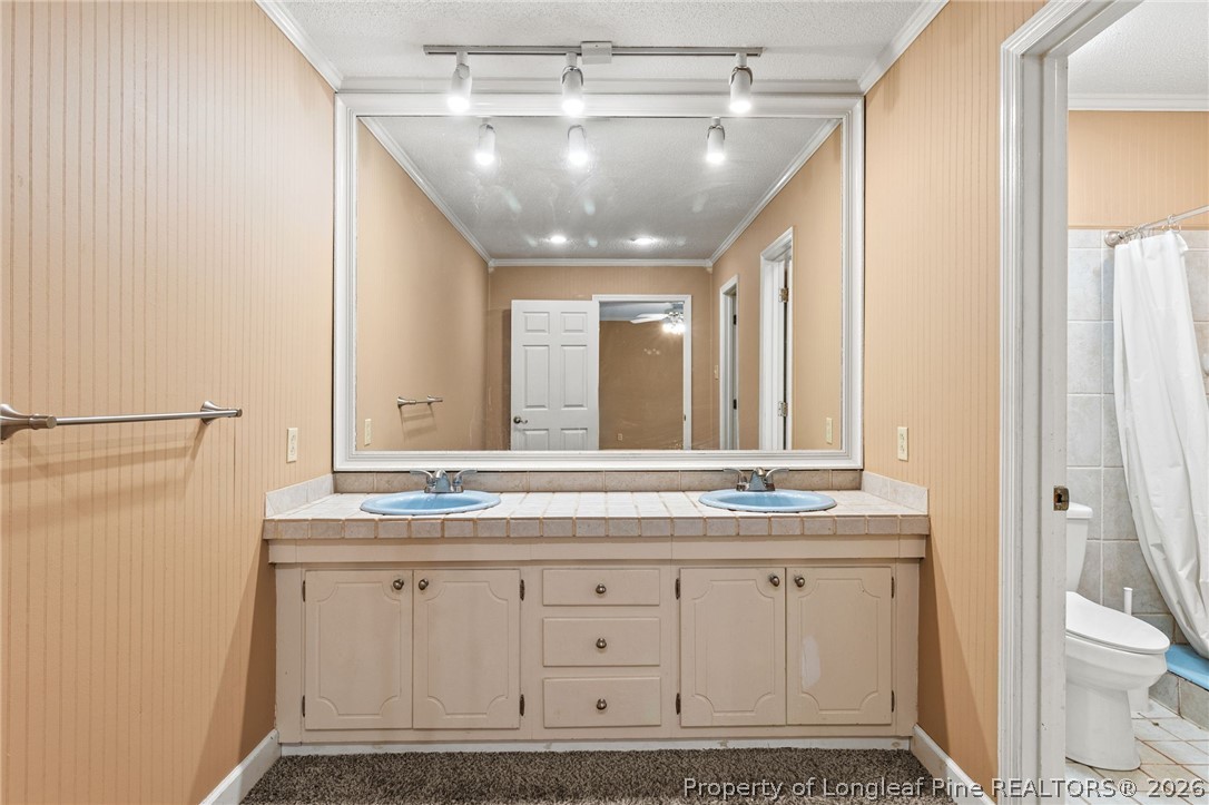 5605 MacGregor Court Fayetteville, NC 28304 - Photo 39 of 49 a bathroom with a granite countertop sink and a mirror
