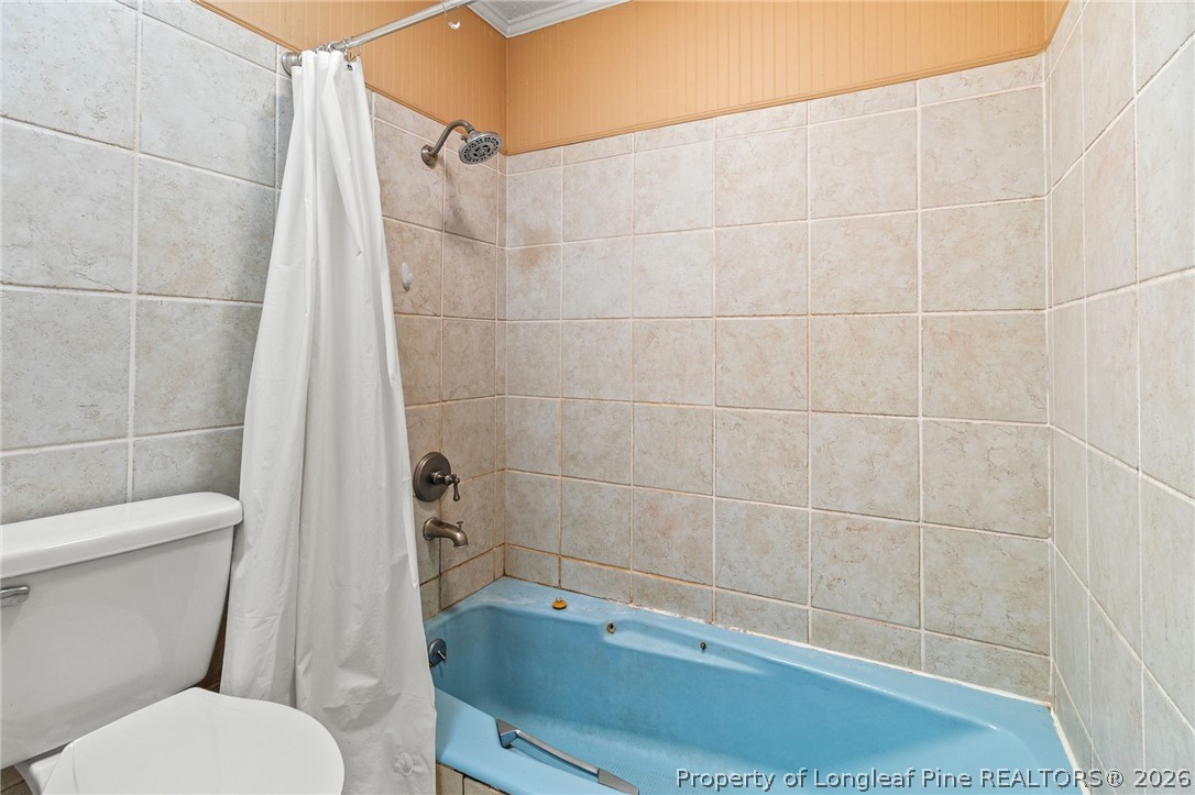 5605 MacGregor Court Fayetteville, NC 28304 - Photo 40 of 49 a bathroom with a toilet and a shower
