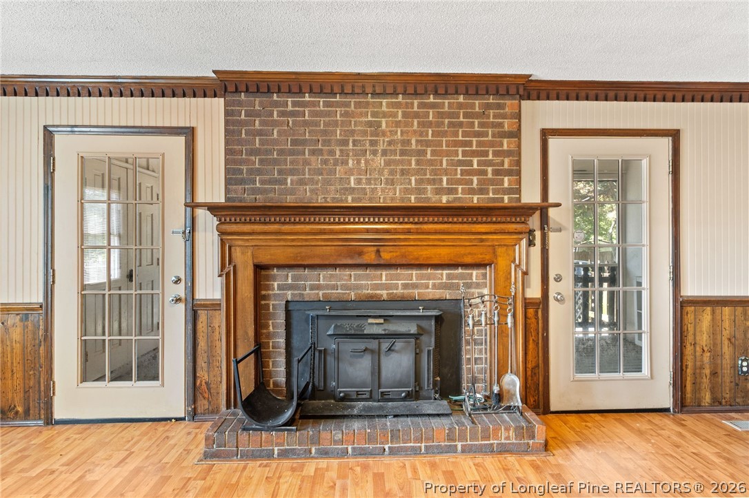 5605 MacGregor Court Fayetteville, NC 28304 - Photo 10 of 49 a living room with a fireplace and a wooden floor
