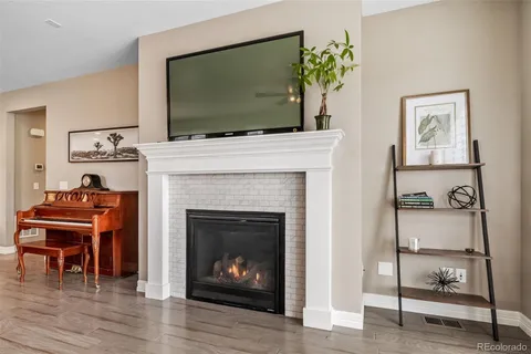 a living room with a fireplace and a flat screen tv