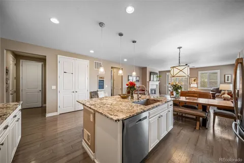 a kitchen with a stove and a wooden floor