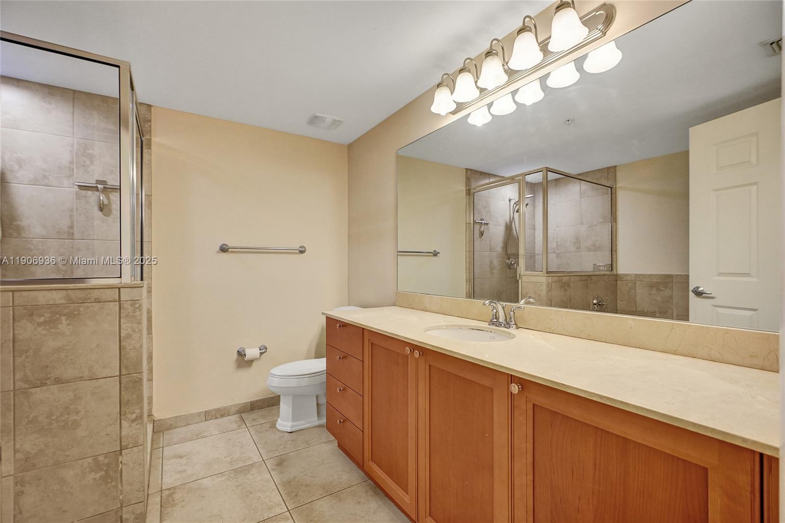 55 Merrick Way, Unit 619 Coral Gables, FL 33134 - Photo 24 of 40 a bathroom with a sink a toilet and shower