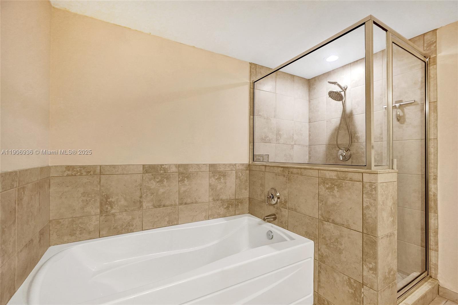 55 Merrick Way, Unit 619 Coral Gables, FL 33134 - Photo 25 of 40 a bathroom with a bathtub and a shower